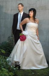 Karine walks on the grass while her husband watches