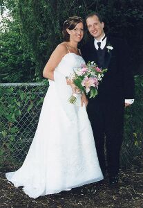 California Christian man stands next to his beautiful Canadian Christian bride