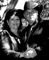 Dancing cowboy under a tree with a happy woman