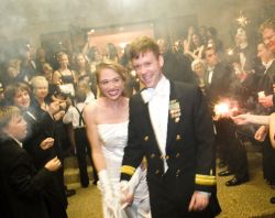 A couple nearly doubled over with laughter at their wedding reception