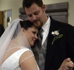 Tennessee Christian woman cuddles in with her new husband who holds her hand