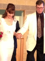 A shy Christian woman smiles as a man takes her hand and they walk together