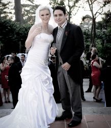 A beautiful Christian couple pose for the cameras outdoors after marrying