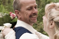 Christian couple laugh comfortably and hug after marrying