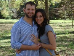 Newly engaged Christians embrace in a park