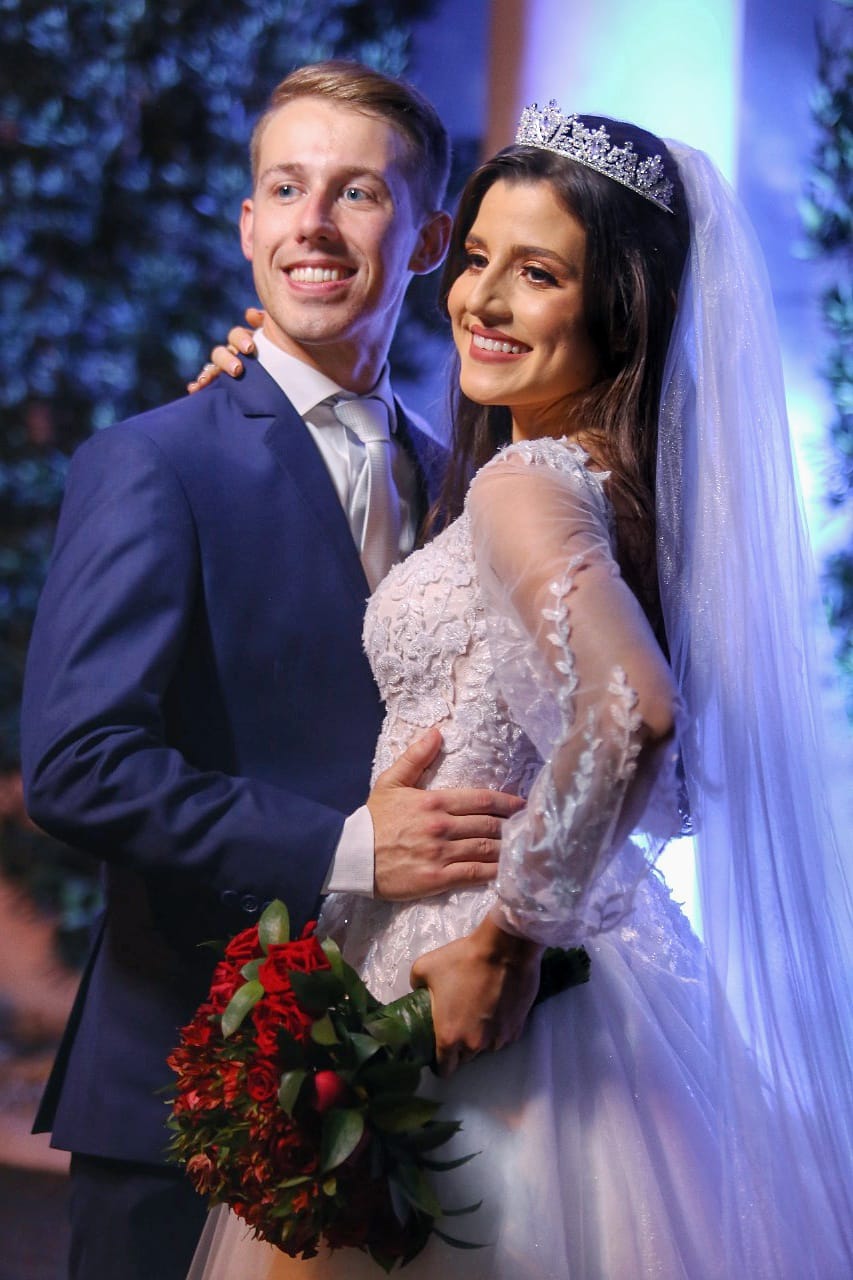 A beautiful Brazilian Christian bride smiles with her new husband