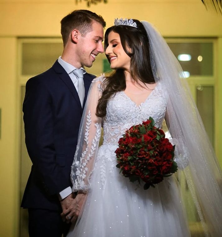 Newlywed Christians laugh before a kiss