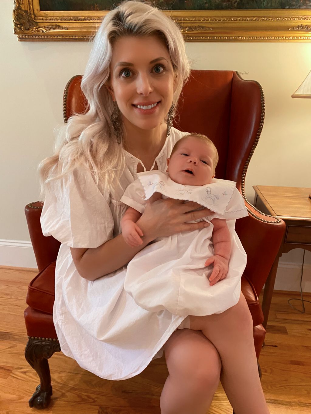 A pretty Christian woman holds her baby while seated