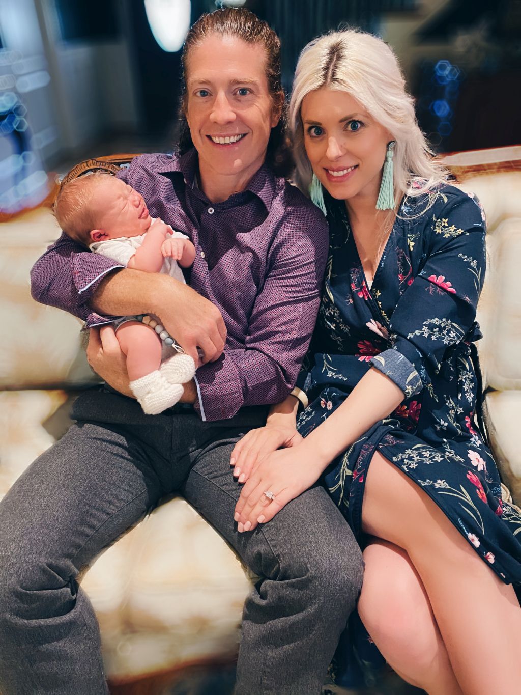 Beautiful Christian couple cuddle with their new baby