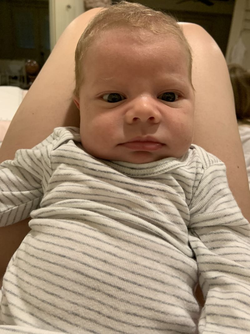 Newborn baby wide awake looking at camera