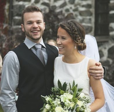 A man looks so happy and has arm around a beautiful smiling woman