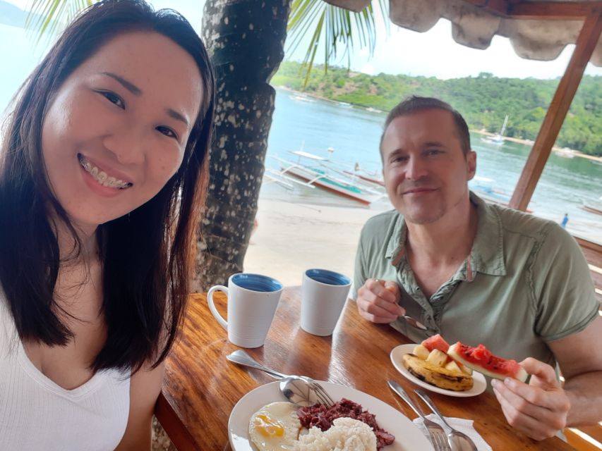 Breakfast by the beach in tropical location for happy smiling couple