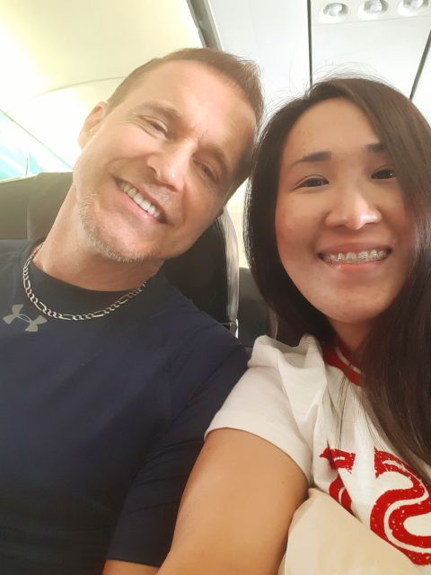 Couple smiling while on plane