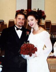 Attractive Christian couple smile at altar after marrying