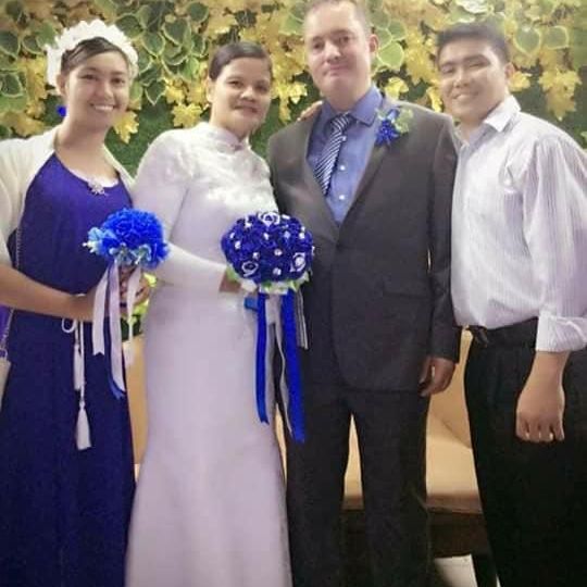 Maid of Honour and Best Man pose with happy Christian couple