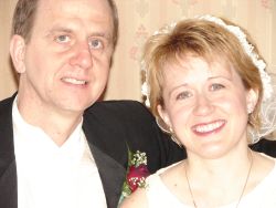 A bride with a beautiful smile stands next to her new husband
