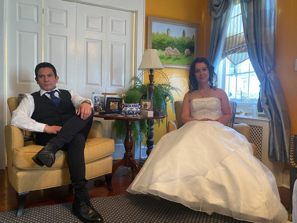 A newly married Christian couple relax in a living room, each seated in an armchair