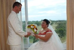 Groom presents a bouquet to bride