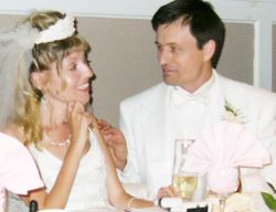 A bride teases her new husband from Ontario as he looks at her affectionately