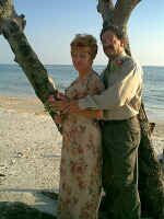 Couple hug in the shade by the ocean