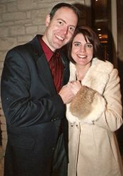 An overjoyed couple of Christian singles hold hands and smile after meeting