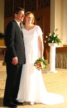 Sonya is no longer single. Bride and groom pose together and laugh in church
