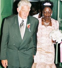 Newly married Christians walk hand in hand after marrying