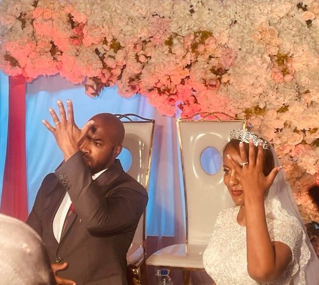 A newly married Christian man and his wife show off their rings right after marrying