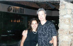 Christian couple hug and smile after traveling to meet in person