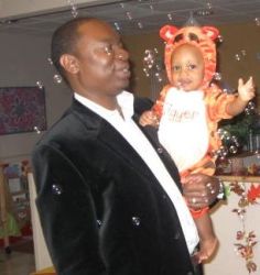Proud father holds his son at Halloween party