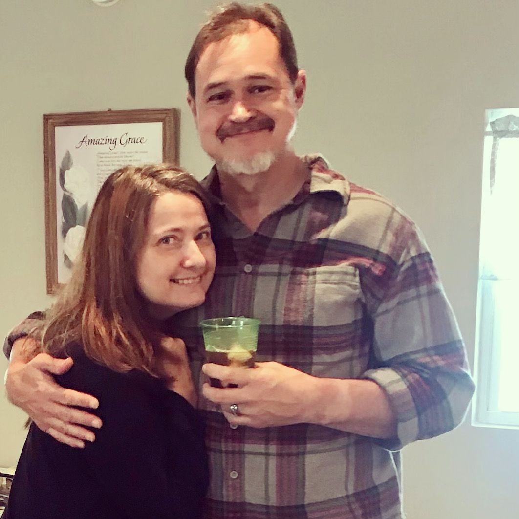 A happy Christian couple hugging while having a drink