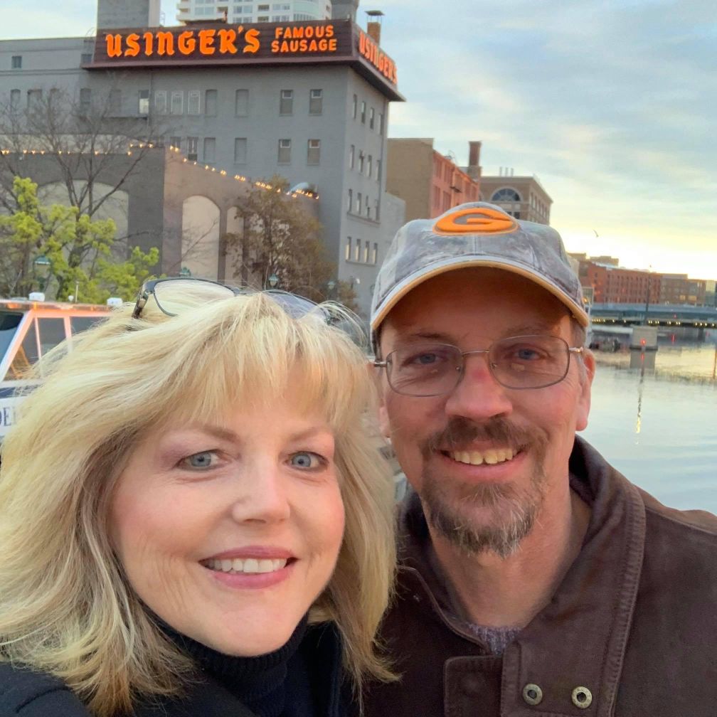 Happily married Christian couple pose at Milwaukee's waterfront