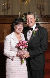A very happy Christian bride stands next to her elated husband in the church