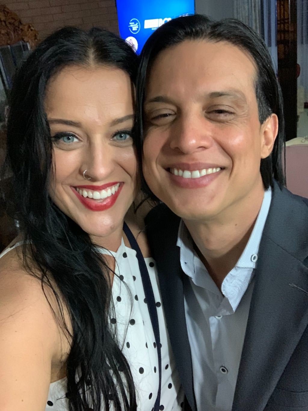 A beautiful White Christian woman and her Latino husband smile for a selfie