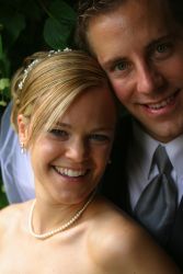Husband photobombs bride as she laughs while taking a selfie