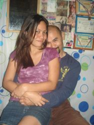 An overjoyed man hugs a woman who sits in his lap