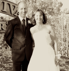 A recently married couple look giddy while standing beside each other