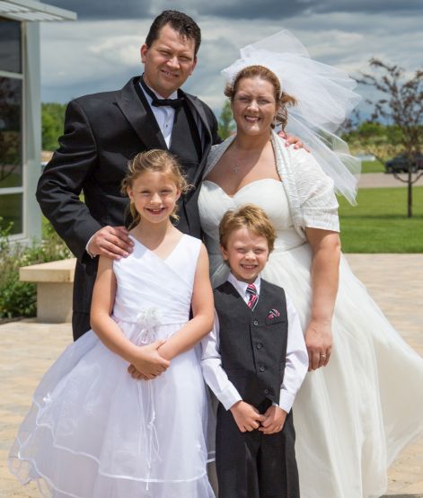 Blended Christian family standing together in heavy winds