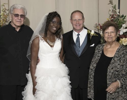 Wedding shot of smiling bride, groom and his parents