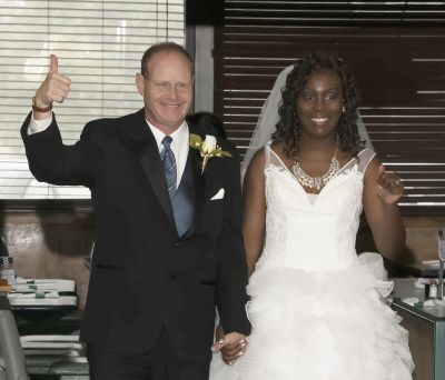 Thumbs up for this wedding indicated by excited groom who holds his beautiful brides hand