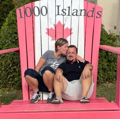 A couple cuddle in giant chair at 1000 Islands in Canada