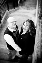 An overhead views of a smiling couple hugging on a path outdoors
